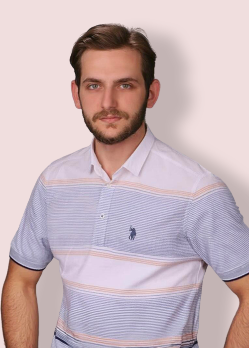 A man wearing a polo shirt with horizontal stripes, standing against a beige background.