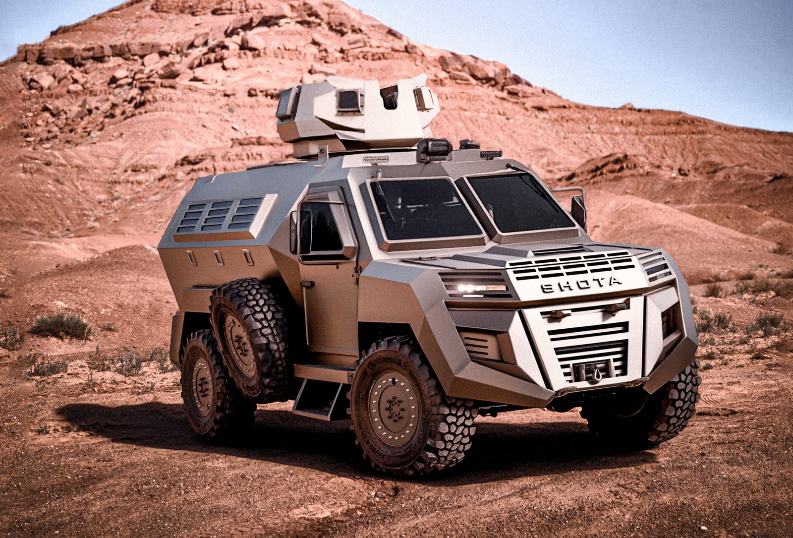 A tan-colored EHOTA armored vehicle situated in a desert landscape with a large rocky hill in the background.